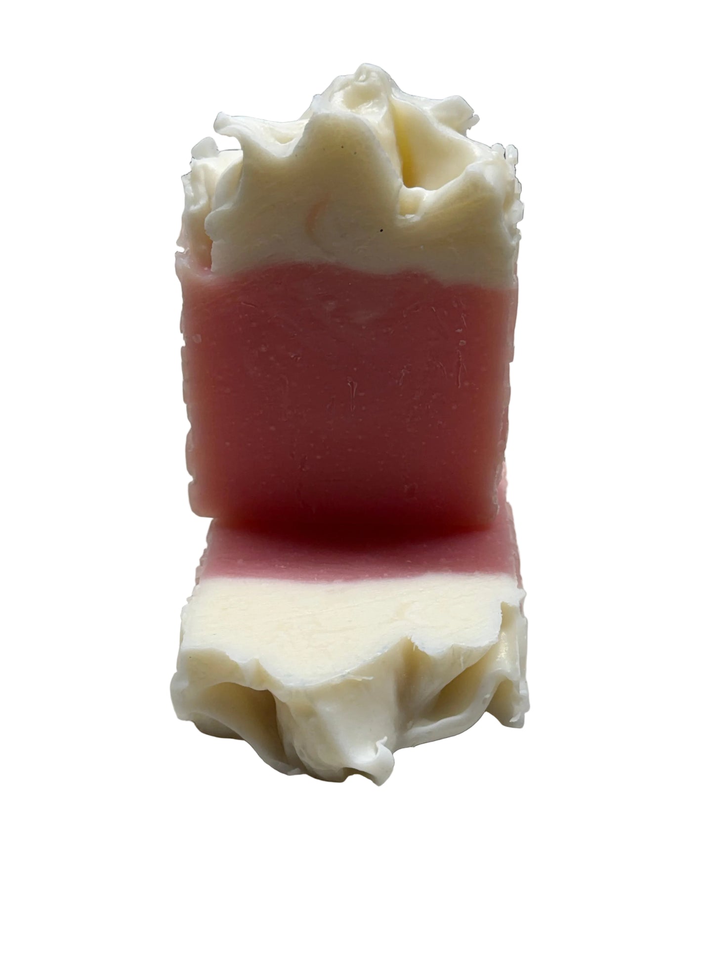 Close-up of a soap bar with decorative white frosting on a white background